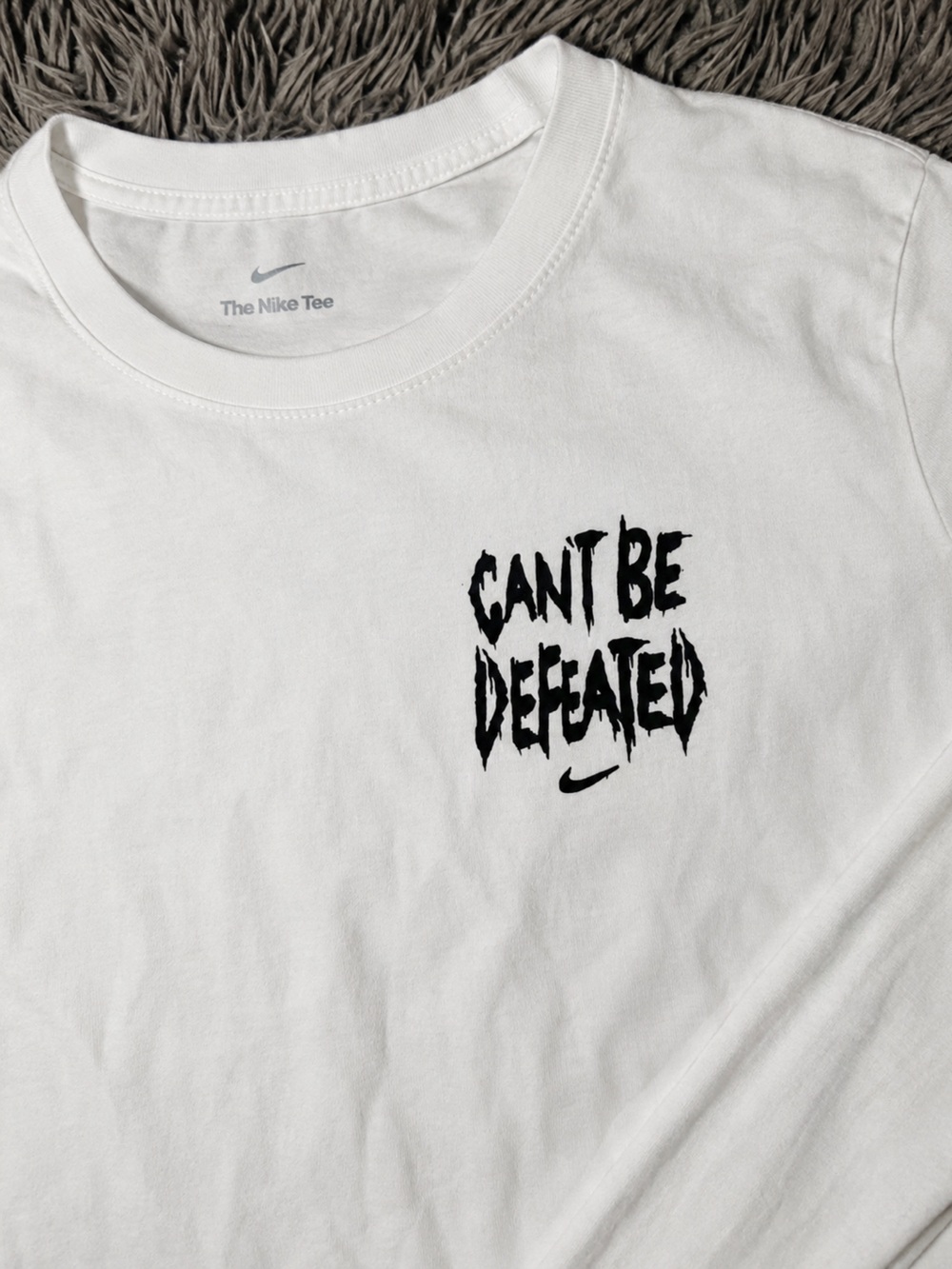 Nike White Short-Sleeve Tee with Black 'Can't Be Defeated' Graphic